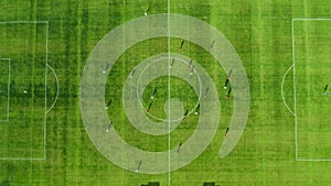 Top view Aerial flight over the football stadium at sunset. Professional players on the field score a goal. Beautiful