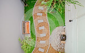 Top view aerial photo from flying drone of Stone walkway winding in garden