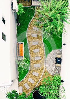 Top view aerial photo from flying drone of Stone walkway winding in garden