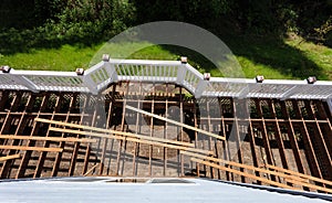 Top view of an aged outdoor wooden cedar deck being tore down due to weathered boards