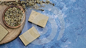 Top view, Aleppo soap and dray Laurus nobilis flower in a wooden plate