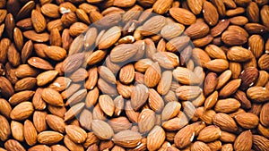 Top view Almond seeds,Pile of almond nuts on wood table,