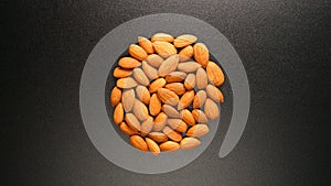 TOP VIEW: Almonds on a black table