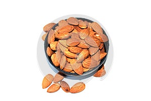 Top view of almonds regular in black bowl isolated on white background