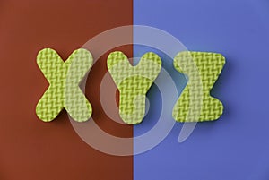 Top view of alphabet XYZ on two color background which are red and blue photo