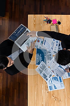 Top view analyst team working on dashboard paper on table. Fervent