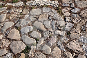 Top view on ancient road paved with cobblestones.