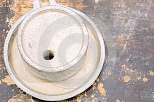 Top view of ancient stone flour mill on black wooden table