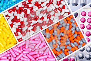 Top view of antibiotic capsules and tablet pills. Antibiotic drug resistance. Superbug. Full frame of multi-colored pills. photo