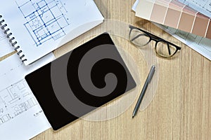 A top view of architect working desk with equipment for drawings pens sketched idea on wood table