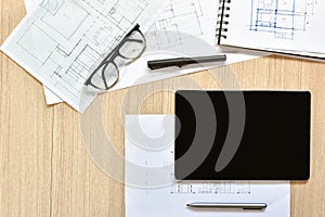 A top view of architect working desk with equipment for drawings pens sketched idea on wood table