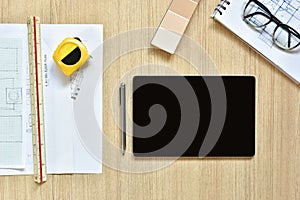 A top view of architect working desk with equipments for drawings pens sketched idea on wood table