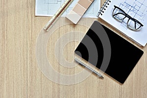 A top view of architect working desk with equipments for drawings pens sketched idea on wood table