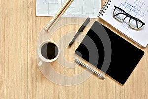 A top view of architect working desk with equipments for drawings pens sketched idea on wood table