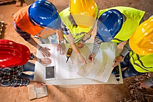 Top view of architects check blue print if construction is going