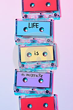 top view of arranged colorful audio cassettes with life is a mixtape inscription