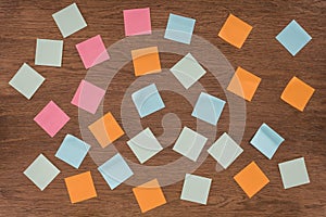 top view of arranged colorful post it notes on wooden