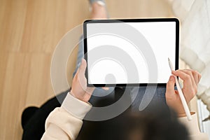 Top view of an Asian woman using her digital tablet in the living room. tablet mockup