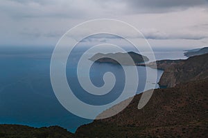 Top view at Asos village and Assos peninsula during bad weather conditions, thunderstorm and rain, with low dark clouds