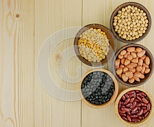 Top view assorted beans on wooden background