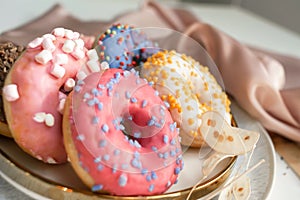 Top view of assorted glazed donuts. Various colorful glazed doughnuts with sprinkles