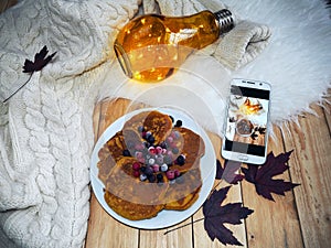 Top view of assorted pancakes with frozen fruits