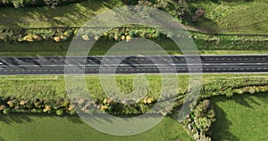 Top view of the autobahn shrouded in green fields in 4k