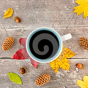 Top View of Autumn Leaves and Mug with Coffee on Rustic Wood