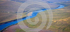 Top view of the autumn Siberian taiga and the Tunguska River with its tributary