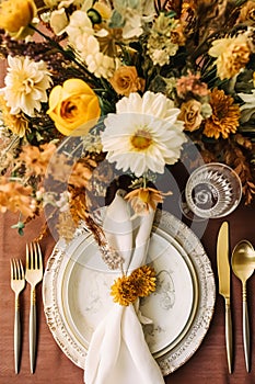 Top view of autumn table scape, autumnal dinner table setting, holiday tablescape for wedding, birthday or party event celebration