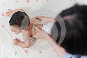 Top view, Baby back massage for stimulate development by mother. Mother makes massage for happy baby. Infant healthcare concept