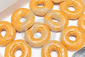 Top view Background of assorted glazed donuts in a box. Unhealthy food concept
