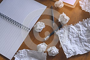 Top view on background of paper, pencil, crumpled paper on wooden table. working,