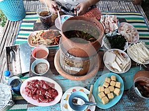 Top view, background of various dishes, Isaan food, clay pot concept.