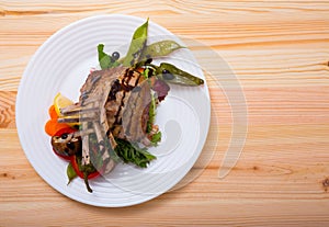 Top view of baked rack of lamb with vegetables