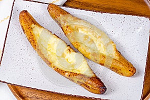 Top view of baked Ripe Plantains with Cheese (Plantain Canoe or Platanos Asados Con Queso) on a plate