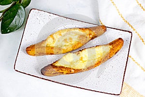 Top view of baked Ripe Plantains with Cheese (Plantain Canoe or Platanos Asados Con Queso) on a plate