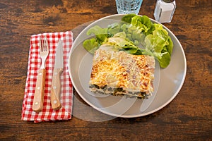 Top view of baked salmon lasagna with cheese and spinach