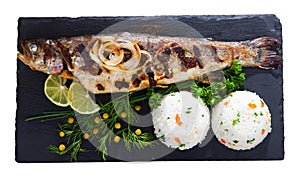 Top view of baked whole trout with rice