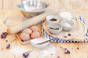 Top View Baking Preparation on wooden Table,Baking ingredients. Bowl, eggs and flour, rolling pin and eggshells on wooden board,