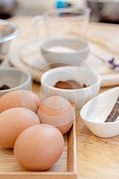 Top View Baking Preparation on wooden Table,Baking ingredients. Bowl, eggs and flour, rolling pin and eggshells on wooden board,