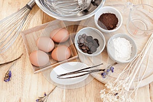 Top View Baking Preparation on wooden Table,Baking ingredients. Bowl, eggs and flour, rolling pin and eggshells on wooden board,