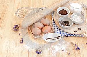 Top View Baking Preparation on wooden Table,Baking ingredients. Bowl, eggs and flour, rolling pin and eggshells on wooden board,