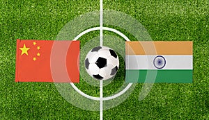 Top view ball with China vs. India flags match on green soccer field