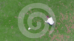 Top view of the ball rolling past the golf hole