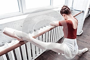 Top view of a ballerinas leg on the barre