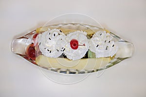 Top view Banana Split Ice Cream in a boat shaped glass cup on white table background,white background,food, copy space