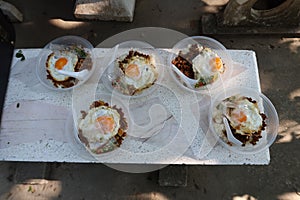 Top view, Basil Fried Rice with Minced Pork and Fried Egg, a popular local dish in Thailand.