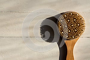 Top view of bath bamboo brush for dry massage om wooden background