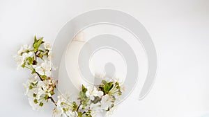 Top view bathroom supplies and spa cosmetic spray bottle and white flowers  on white background . copy space